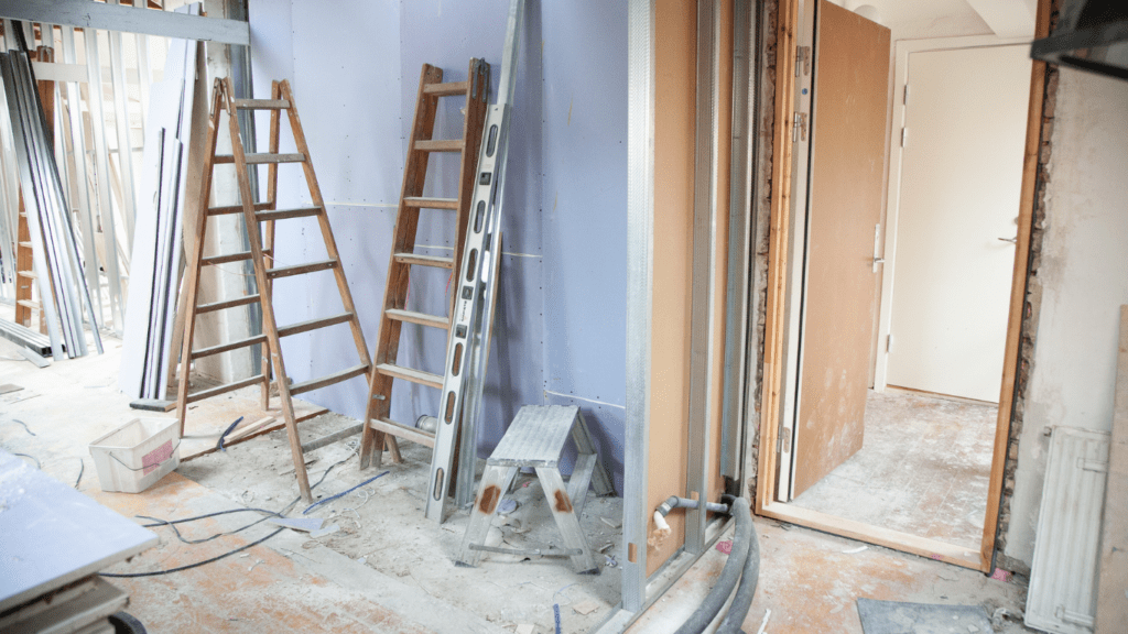 a room that is being remodeled with a ladder and other tools