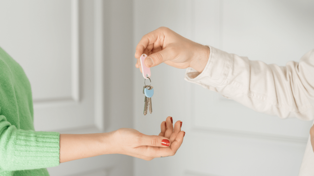 a person handing a key to another person