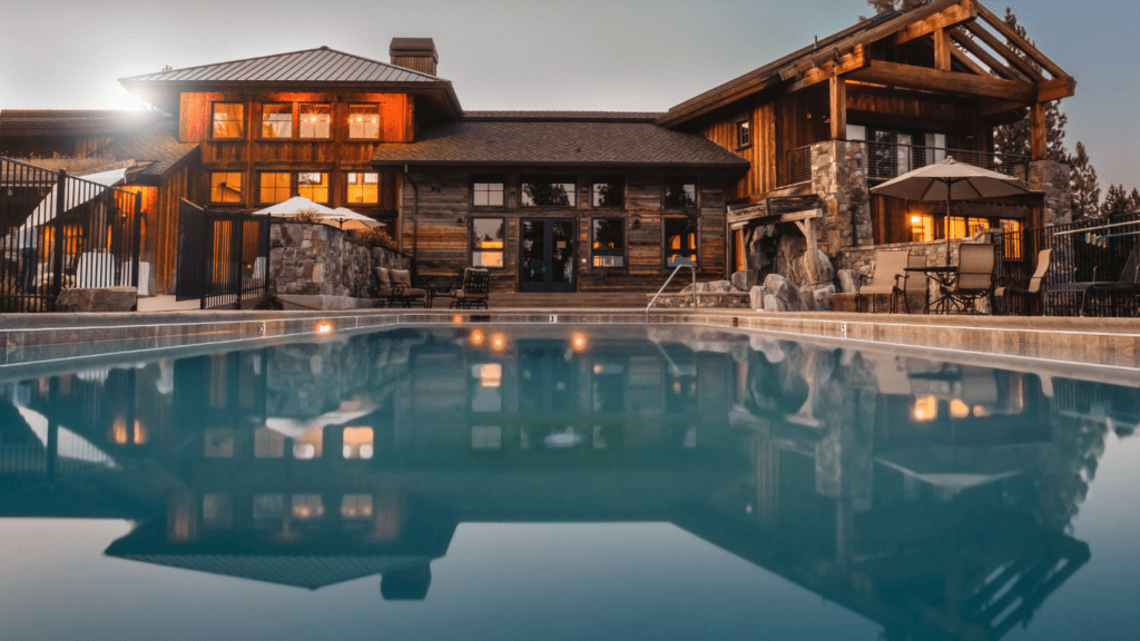 a large house with a pool in front of it