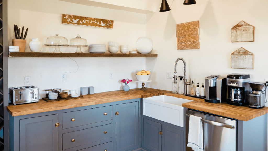 a kitchen with blue cabinets and wooden counter tops