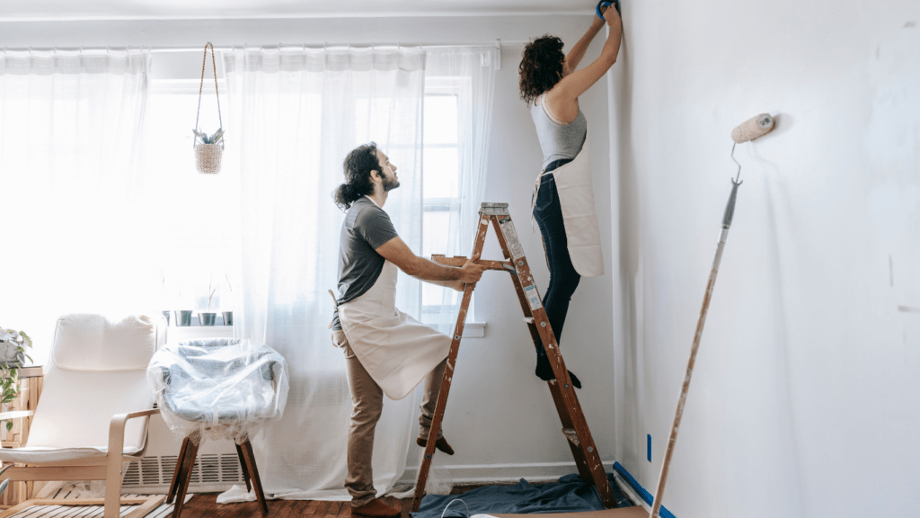 a person painting a house