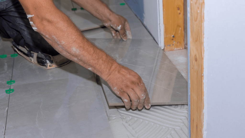 a person is laying tile on the floor