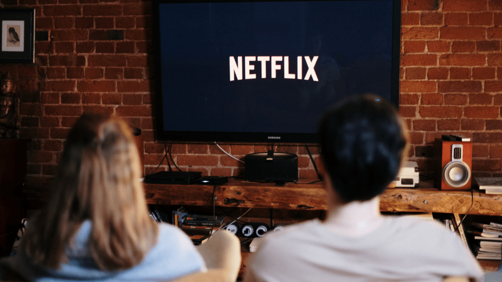 people sitting in front of a television watching Netflix