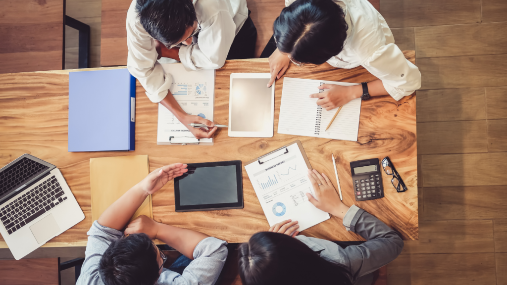 a group of people sitting around a conference table