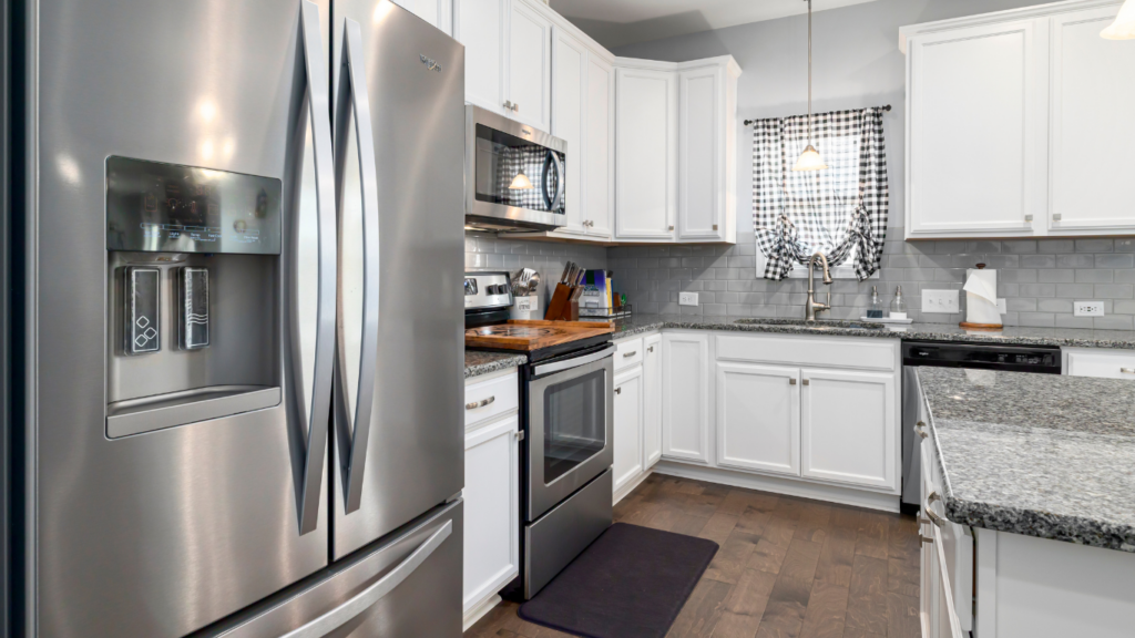 a kitchen with stainless steel appliances and a washer and dryer