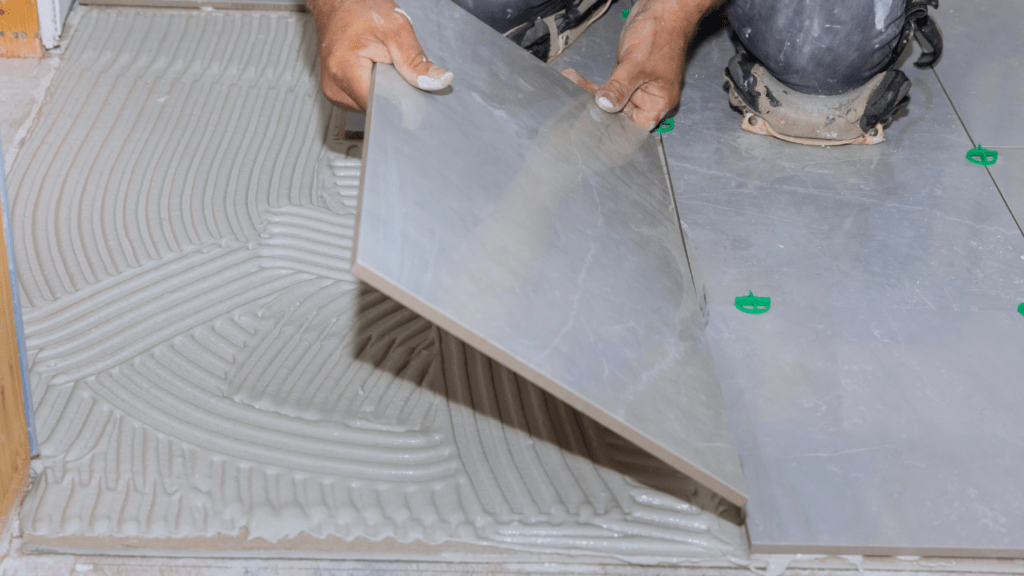 a person is laying tile on the floor