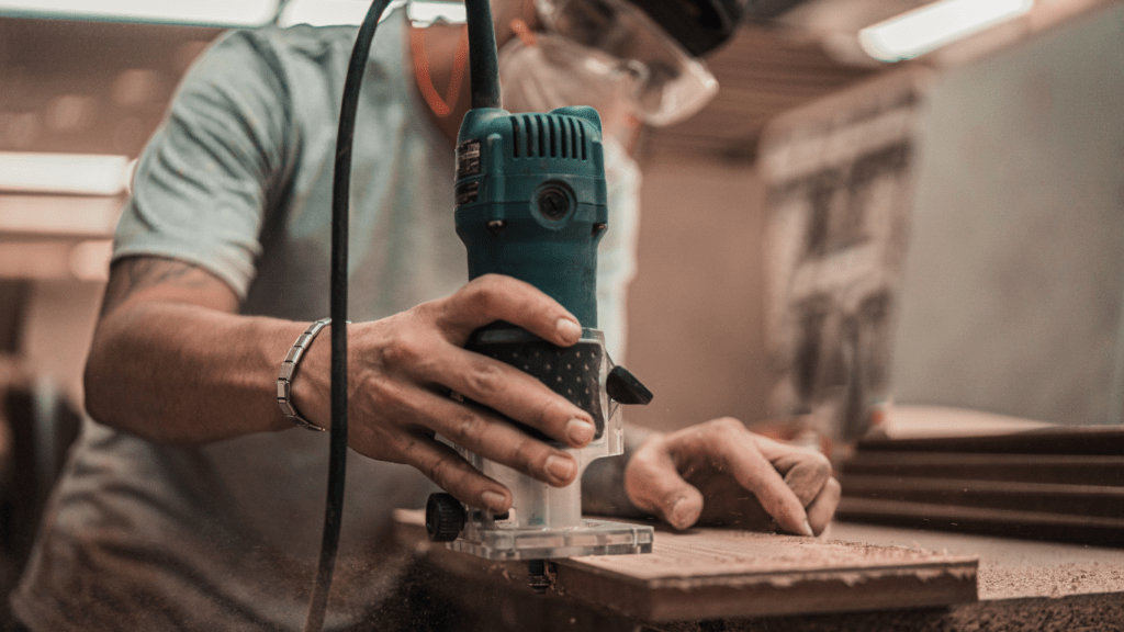 a person using a cordless drill on a wooden floor