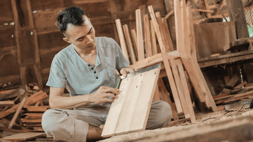 a person working on a piece of wood in a woodworking shop