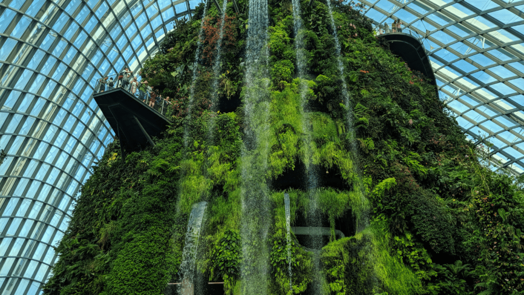 an office building with green trees and sky in the background